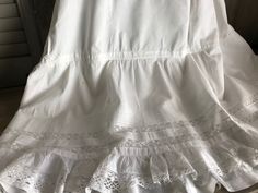 "French Fine Lace Petticoat ca. Early 1900s 4291801 IW Amazing fine cotton/linen and lace petticoat from the early 1900s. Double layered with the under ruffled underskirt. Beautiful lace inserts and tiny tuck seam design with lace bottom. All hand worked. Gathered at the top with a mother of pearl button closure. Measures; 39\" length, 30\" waist, generous size for this era. Beautiful and clean condition with a few small marks and rust spots (somewhat faded), nothing too off putting. There is he Vintage Fitted Petticoat For Daywear, Vintage Crinoline Petticoat For Spring, Spring Vintage Crinoline Petticoat, White Vintage Crinoline Petticoat, Summer Vintage Crinoline Petticoat, Victorian White Ruffled Petticoat, Victorian White Petticoat With Ruffles, Victorian Wedding Petticoat With Attached Cancan, Victorian Wedding Petticoat With Cancan