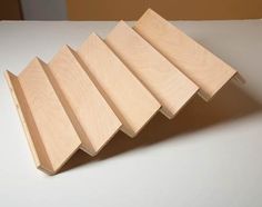 five pieces of plywood sitting on top of a white counter next to each other