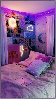 a bedroom with pink and purple lights on the ceiling