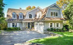 a large house with lots of windows and white shutters