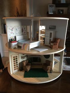 a doll house with furniture inside of it