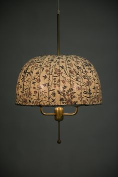 an old fashioned lamp hanging from a ceiling