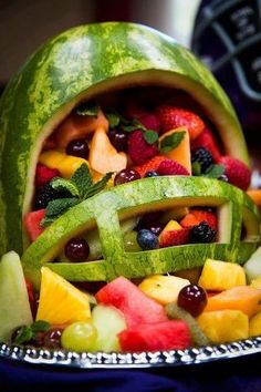 a watermelon shaped like a football helmet filled with fruits and veggies