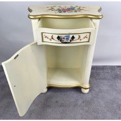 an antique white and gold painted corner cabinet