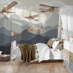 an airplane themed bedroom with wooden floors and walls painted in shades of gray, beige and white