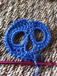 crochet scissors and yarn on woven surface