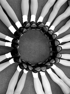 a bunch of dolls are arranged in a circle on the floor with black and white socks