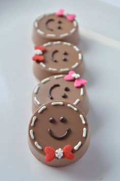 three chocolate candies with faces and bows on them