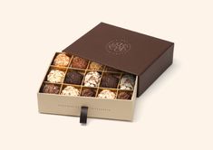 an open box of assorted chocolates on a white background