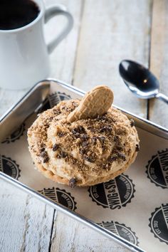 a cup of coffee and some cookies on a tray