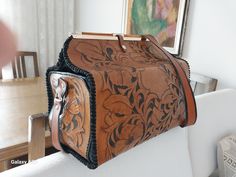 This handmade large bag is made of high-quality cowhide and decorated with Western-style embroidery. This bag, which can be carried both on the shoulder or as a crossbody strap, is ideal for daily use with its large internal volume and durable structure. While hand-carved details give the bag an elegant and original appearance, the leather material offers long-lasting and stylish use. This stylish and functional bag, which will complement your style both for work and travel, combines fashion and functionality. Are you tired of boring bags that don't show your unique style?  Our Leather Bag is here to solve that problem. This one-of-a-kind suitcase-style brown bag is perfect for all the lovely ladies out there! Crafted with love from 100% natural leather, it's not just a bag; it's a stateme Artisan Hand Tooled Shoulder Bag For Travel, Traditional Hand Tooled Satchel For Travel, Traditional Hand-tooled Satchel For Travel, Traditional Brown Satchel, Hand Tooled Leather Shoulder Bag For Travel, Artisan Hand Tooled Bag For Travel, Artisan Hand Tooled Travel Bag, Luxury Hand Tooled Satchel For Travel, Luxury Hand-tooled Satchel For Travel