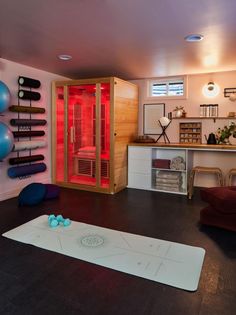 a living room with a red hot tub in the corner and various objects on the wall