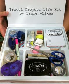 the contents of a travel project life kit are organized in a white box with scissors and tape