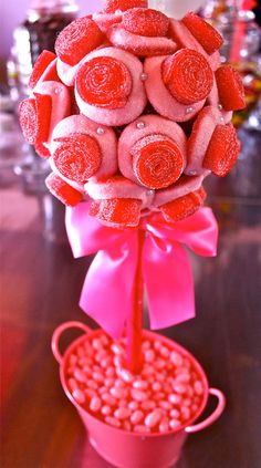 a pink candy bouquet in a red bucket