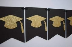 three black and gold graduation banners with golden tassels