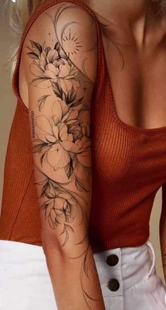 a woman with a flower tattoo on her arm