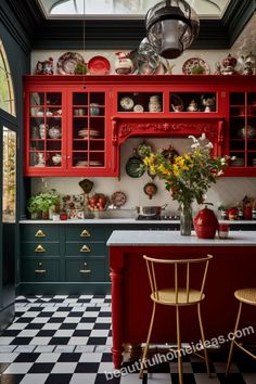 a kitchen with red cabinets and black and white checkered flooring, yellow chairs