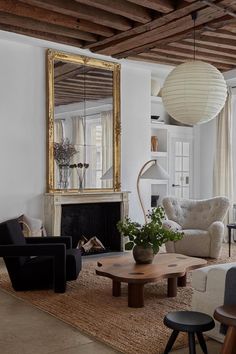 a living room filled with furniture and a large mirror on the wall over a fire place