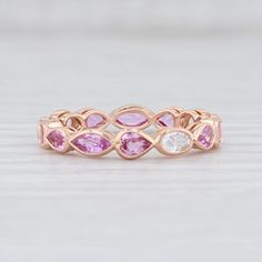 Gem: Natural Sapphires - 2.54 Total Carats, Oval / Pear / Marquise Brilliant, White and Pink Color, Heat TreatmentMetal: 14k Rose GoldWeight: 2.4 Grams Stamps: 14k bkc BKBand Width: 3.7 mm Rise Above Finger: 3 mmThis ring is a size 6 1/2. If you need your ring sized please click HERE and purchase the appropriate fee amount along with your ring. Once a ring is resized, we guarantee the work but we are unable to offer a refund on the sizing. Please contact for additional sizing options. Each piece Mens Custom Jewelry, Sapphire Eternity Band, Stackable Wedding Bands, Gold Rings Stackable, White Sapphire Ring, Stackable Bands, Rise Above, Band Jewelry, Blue Sapphire Rings