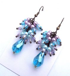 Cluster earrings, aqua blue crystal cluster earrings. Beautiful aqua blue faceted briolette crystal beads accompanied by pastel purple and pastel blue smooth round pearl beads with aqua blue and lilac purple bi-cone accent beads. These earrings are truly elegant whether you pair them with your favorite jeans or wear them on a nice dinner date. Your choice in either antique bronze lever back earrings closures or antique bronze French hook earrings closure with safety ear stoppers. Earrings are super lightweight and can be worn comfortably all day long. A one-of-a-kind gift for yourself? or someone special? birthday gift? coworker gift? Crystal Cluster Earrings, Violet Pastel, Nice Dinner, Drop Earrings Silver, French Hook Earrings, Special Birthday Gifts, Bleu Pastel, Dinner Date, Pastel Purple