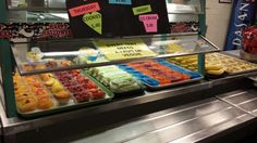 a display case filled with lots of different types of desserts