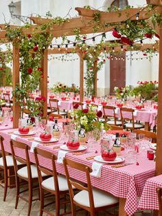 the tables are set with pink and white checkered tablecloths