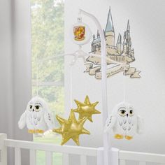 a crib with an owl, star and castle decoration