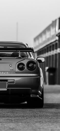 a black and white photo of a sports car