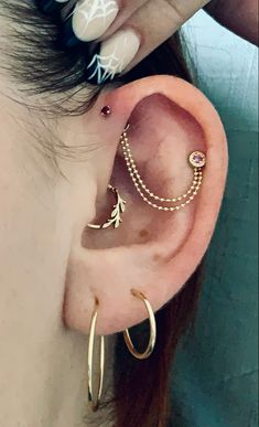 a close up of a person's ear with piercings