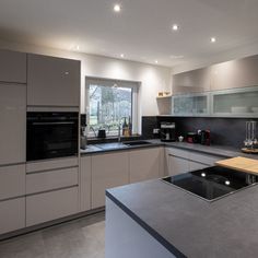 a modern kitchen with stainless steel appliances and counter tops