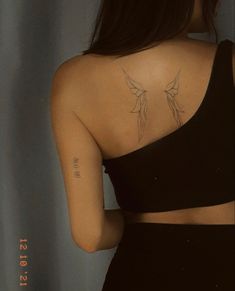 the back of a woman's shoulder with tattoos on her left arm and chest