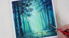 a person is painting a forest scene with blue and green colors