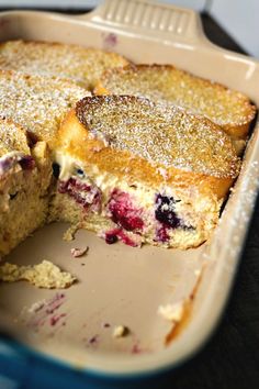 blueberry cobbler cake in a baking dish with one slice cut out and ready to be eaten