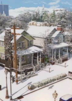 a snow covered city street with houses and trees