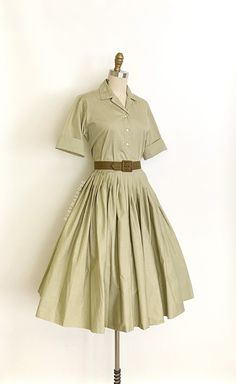 "vintage dress  Era: 1950's Label: Miss Pat. California. Sanforized. Closure: top * button front, skirt * side metal zipper, button waist Material: cotton Colour: muted olive green  Details: versatile two piece top and skirt set, original matching belt, timeless silhouette, optional turn up cuffs, full pleated skirt Fits like: small * top * Bust: 39\" Shoulders: 14.5\" Waist: 36\" Length: 22\" * skirt * Waist: 26\" Hips: free Length: 28\" (5.5\" hem allowance) Condition: The set feels like its never been worn/possibly deadstock. The top has a tiny spot on the back of the hem. Skirt is in excellent condition. Priced accordingly.   shop policy  * All items are a final sale. No returns, exchanges and, order cancellations are not accepted.  * Ruby Mae Rose is not responsible for lost or stolen Ruby Mae, Matching Skirt Set, Muted Green, Skirt And Top Set, Belt Dress, Rose Vintage, 50s Vintage, Skirt Belt, 50s Dresses