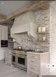 a kitchen with an oven, stove and cabinets in it's center island area