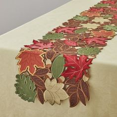 the table is covered with an intricately designed leaf design on it's edge