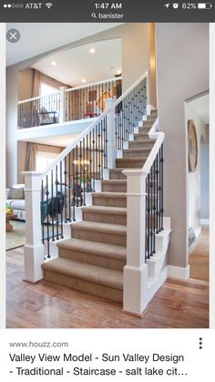 a living room filled with furniture and a stair case