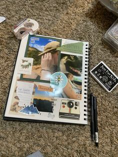 an open notebook with pictures and other items on the floor