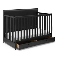 a black crib with two drawers underneath it