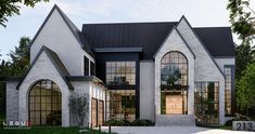 a large white brick house with arched windows