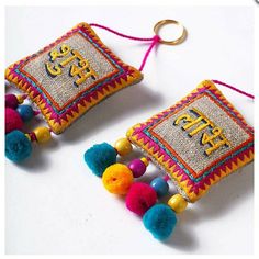 two decorative ornaments with tassels and beads