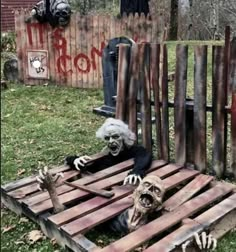 an outdoor display with fake skeletons and wooden slats