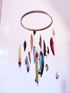 a mobile made out of different types of fish hanging from it's sides in a room