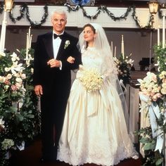 a bride and groom standing in front of an altar