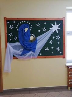 an image of a nativity scene hanging on the wall in a room with tile flooring