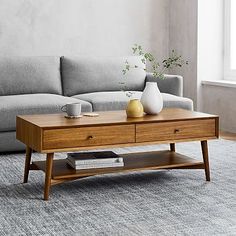 a living room scene with focus on the couch and coffee table in the foreground