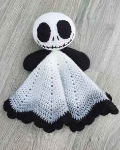 a crocheted jack skellingy doll laying on the floor