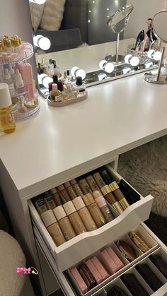 an organized vanity with makeup and cosmetics on it