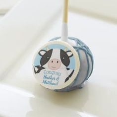 a cake pops with a cow on it sitting on top of a white countertop